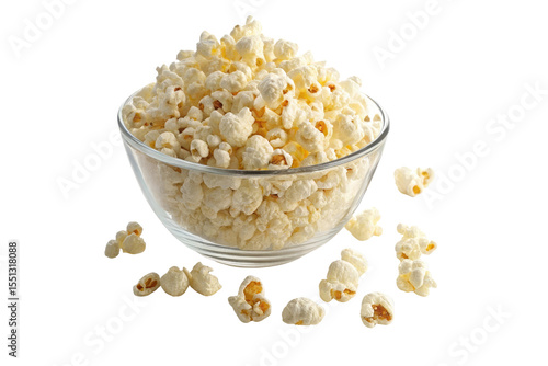 A clear bowl filled with white popcorn and some scattered around on a black background close up shot