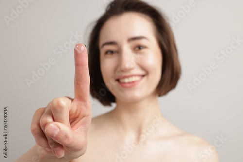 Wallpaper Mural Woman with contact lens on light background, selective focus Torontodigital.ca