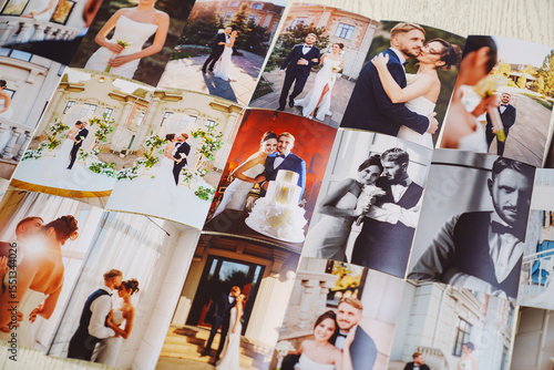 Printed wedding photos laid out on a wooden surface.