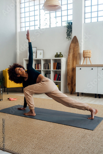 Young woman with hand raised working out at home