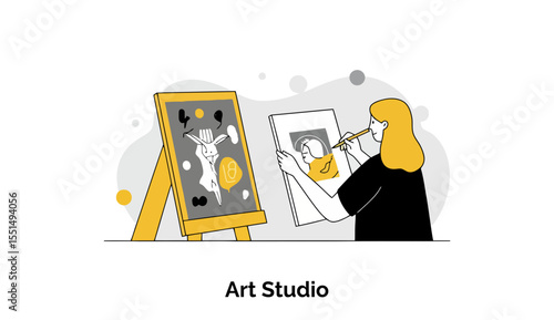 Young woman artist in black clothing painting at an art easel with abstract artwork in the background. Female artist concentrating on canvas in an art studio setting.