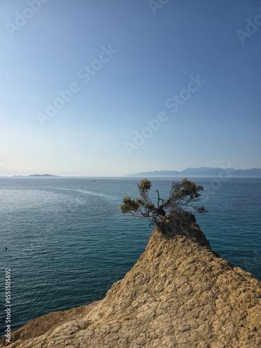 A minimalist view of a clay rock promontory at Canal d'Amour, Corfu, on a clear summer day.