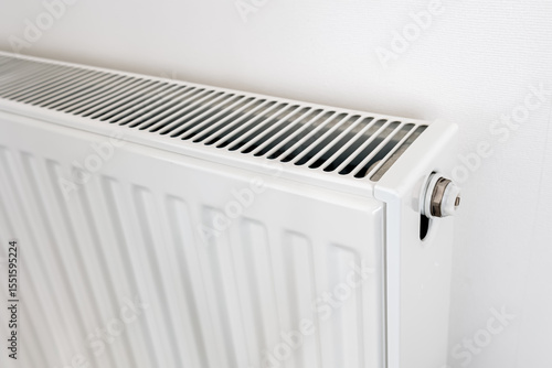 Wallpaper Mural Close-up of a modern white radiator with metal valve and ventilation grille on top, showing heating technology and clean minimalist home interior Torontodigital.ca
