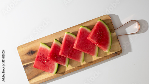 Slices of luscious watermelon languish on rustic board, evoking summer picnics, National Watermelon Day, culinary nostalgia, vibrant refreshment