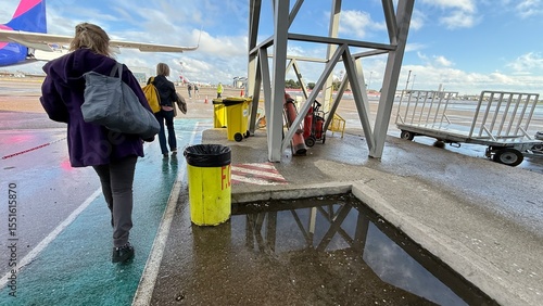 Photography Rain-soaked tarmac reflections capture travelers anticipation on a languid layov
