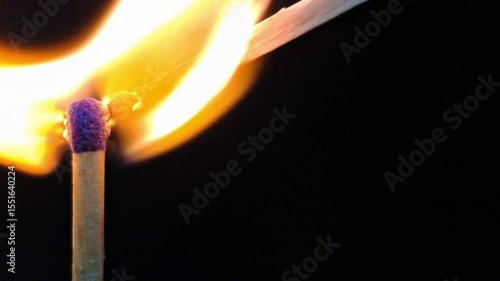 burning candle flame on black background, dark moody atmosphere 