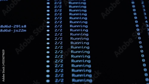 Close-up dark monitor displaying Running and ContainerCreating statuses, illustrating active software development, backend operations, or IT management