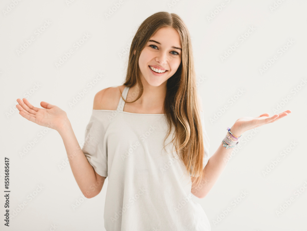 Portrait of teenage girl in casual t-shirt on light background in studio. Portrait of teenage girl in casual t-shirt on light background in studio.