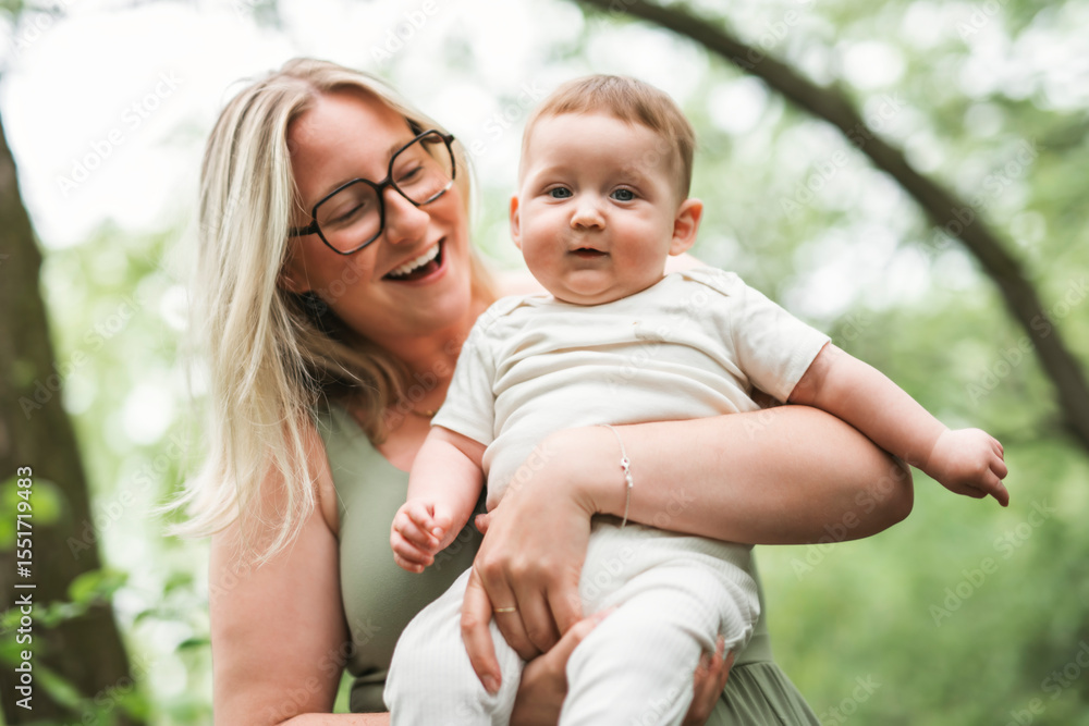 Happy family on a summer meadow. little girl child baby daughter with mother Happy family on a summer meadow. little girl child baby daughter with mother