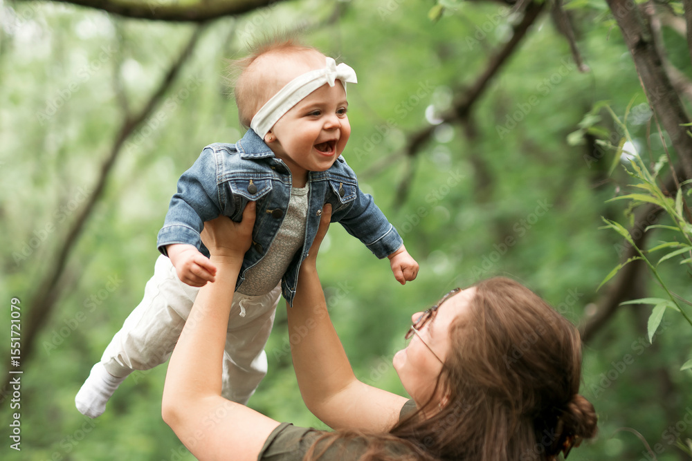 Happy family on a summer meadow. little baby child daughter with mother Happy family on a summer meadow. little baby child daughter with mother