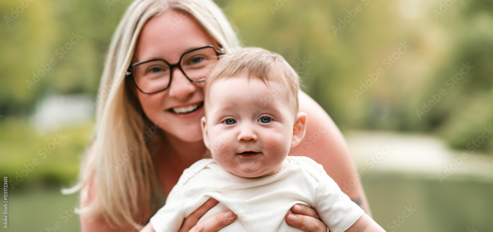 Happy family on a summer meadow. little girl child baby daughter with mother Happy family on a summer meadow. little girl child baby daughter with mother