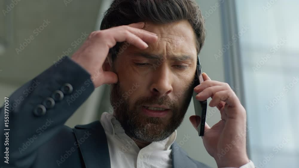 Close up unhappy frustrated Caucasian middle-aged business man talking mobile phone call failure upset in office worry stressed 40s businessman male talk smartphone problem discuss suffering headache