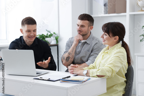Couple having meeting with business consultant at table in office