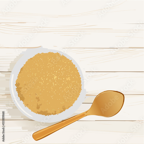 Overhead view of a bowl of granola with spoon on wooden table.