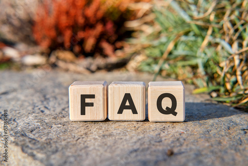 Fag text on cubes standing on a stone on a natural background