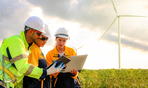 Male and female engineers team walk together wind farm standing tall against cloudy sky sharing ideas about renewable energy from the earth reviewing plans and collecting data on completed mission.