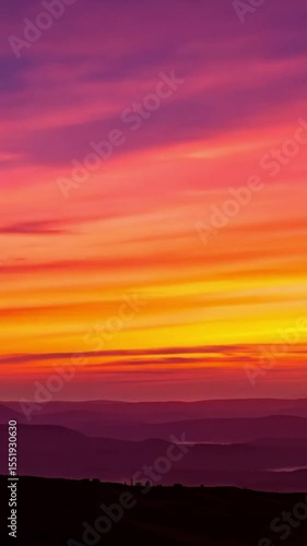 Sunrise over layered hills, vibrant colors