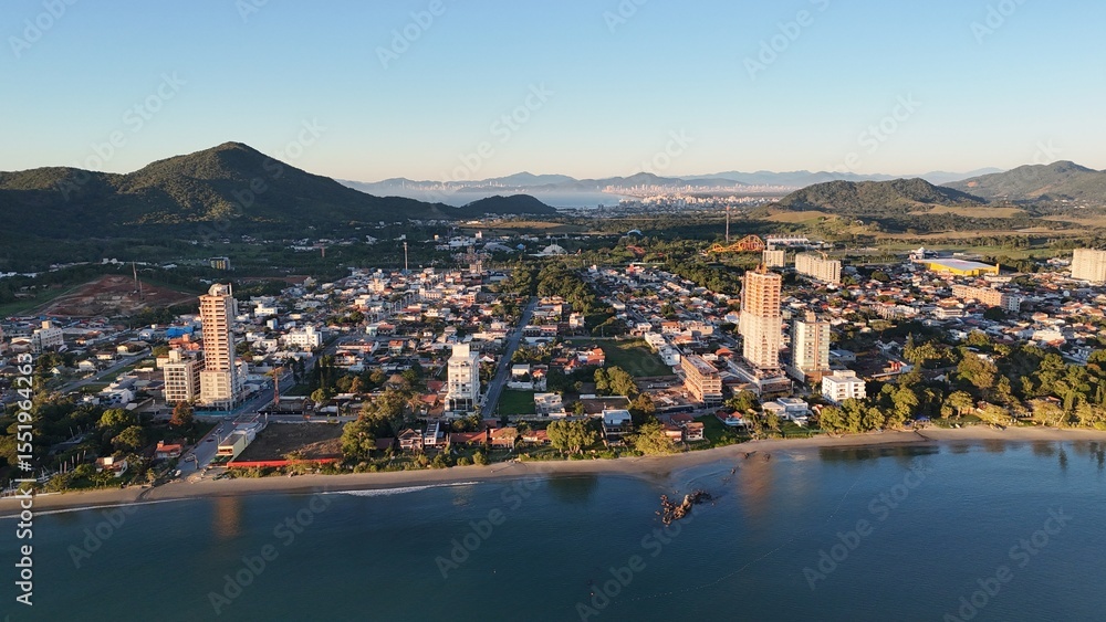 Fototapeta premium First light touches the ocean as the day begins — golden skies, calm seas, and nature in perfect balance along the Brazilian coast.