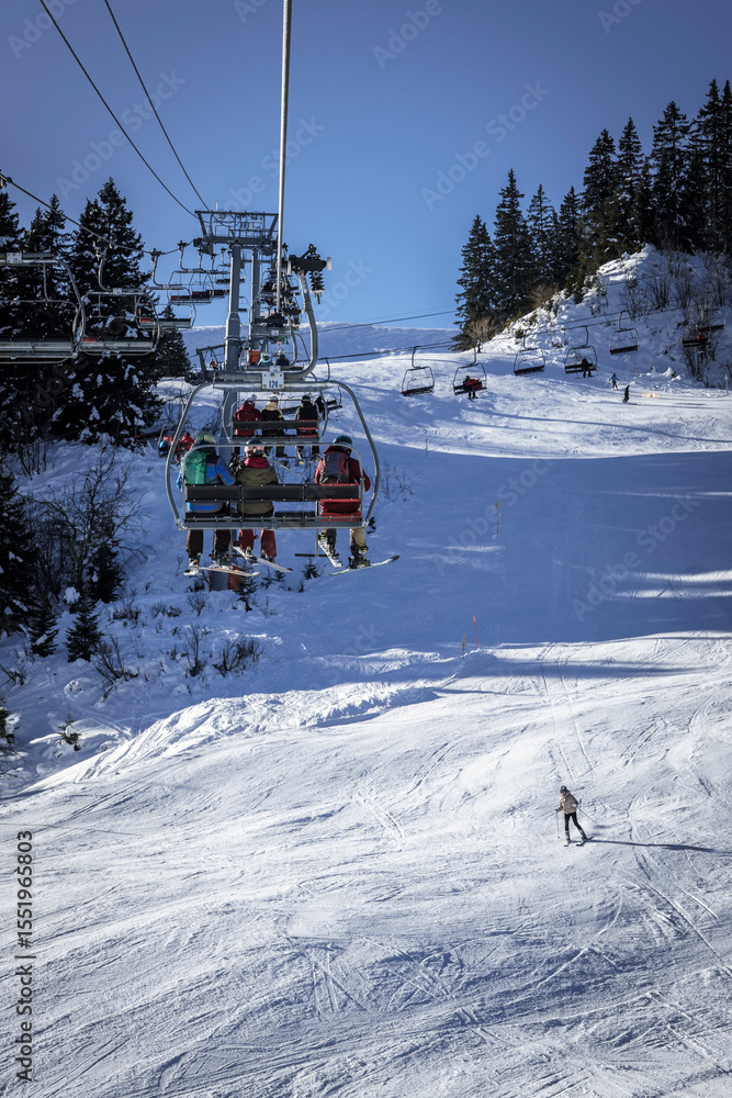 Obraz premium Family on a chairlift, Megève ski resort, Haute-Savoie, France