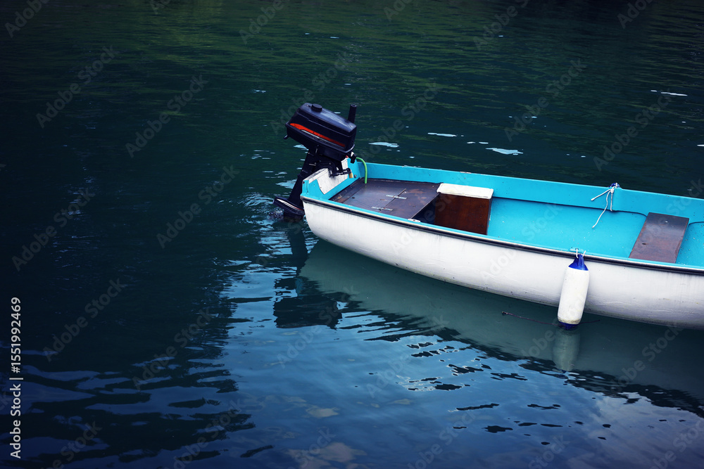 Naklejka premium motorboat motor boat at the pier, white boat on blue water