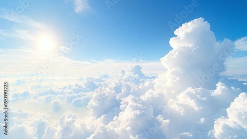 Wallpaper Mural Heavenly Heights: Witness the splendor of a breathtaking celestial vista, where billowy white clouds dance across a vibrant blue canvas, illuminated by the radiant sun. Torontodigital.ca