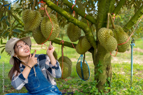 Durian farmer girl smiles sweetly to welcome Thai durian season