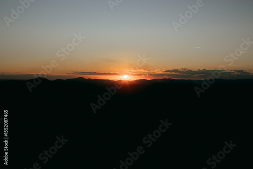 Reddish, golden and orange sunset between mountains