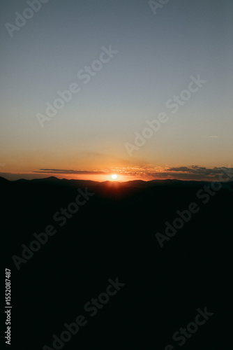 Reddish, golden and orange sunset between mountains