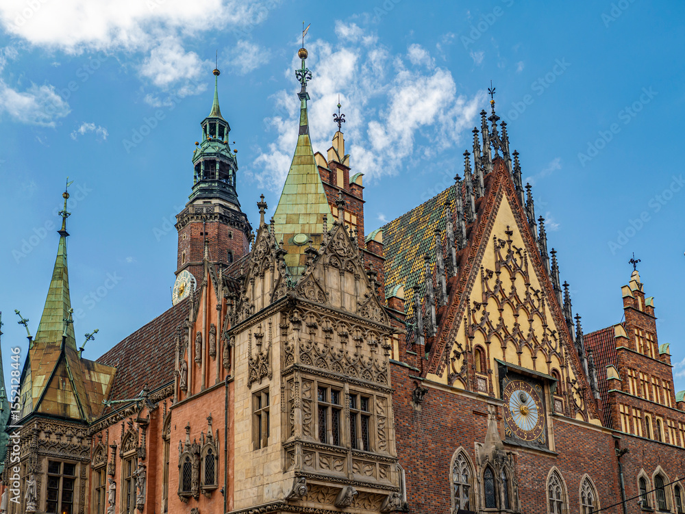 Fototapeta premium Gothic Architecture of Historic European Town Hall Building Against a Blue Sky, Wroclaw, Poland