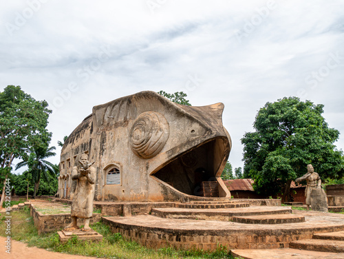 Chameleon-shaped Vodun temple near Abomey, Benin, on a cloudy afternoon