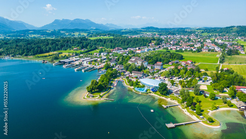 Aerial view of Prien am Chiemsee, a charming Bavarian town on the shore of Lake Chiemsee. Captured in summer, perfect vacation vibes with clear water, green landscapes, and sunny weather