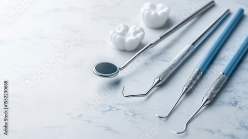 Dental tools arranged on a light surface.