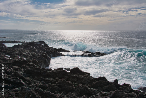 Waves breaking on the rocks in a beautiful sunset