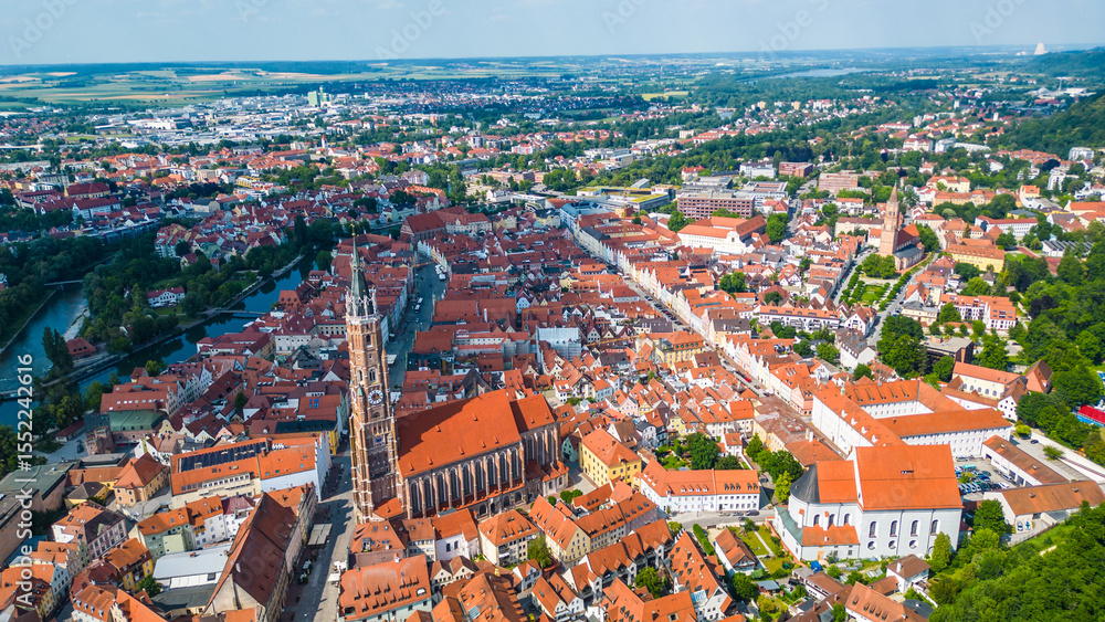 Fototapeta premium Landshut, a vibrant Bavarian town, viewed from the air. Features the medieval Trausnitz Castle on a hill and the striking Church of St. Martin with the tallest brick tower in the world