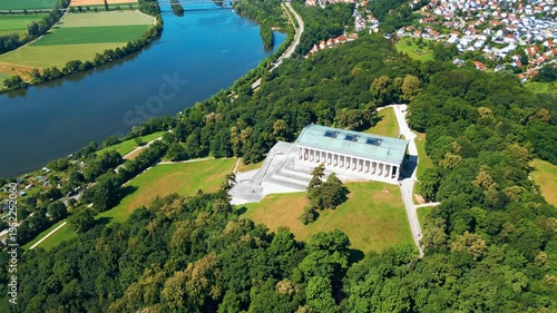 Walhalla memorial near Regensburg captured from a drone on a sunny day, perched above the Danube River with classical architecture and panoramic views of the Bavarian countryside