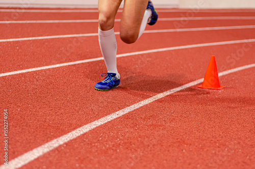 Close-up of a runner's feet in track shoes captured during an intense sprint on the racing lane