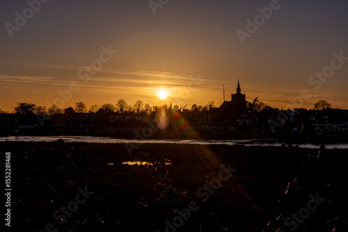 sunset over the river with tower