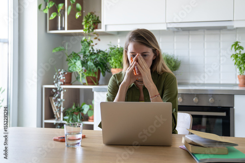 Bild auf Leinwand Upset overwhelmed woman with head in hands work on laptop exhausted from work study with burnout and stress