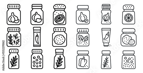 Set of jars with various spices and herbs. The jars are lined up in a row, with some containing garlic, others containing salt, and a few containing pepper. The jars are all different sizes