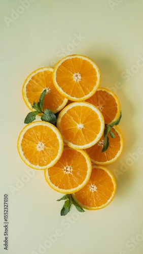 orange slices with mint on pastel background, orange slices fresh citrus fruit concept, orange slices healthy food composition
