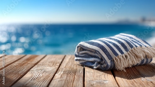 Blue and White Striped Beach Towel on Wooden Deck