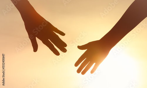 Obraz na płótnie People helping each other giving a helping hand on sky sunset background, Family