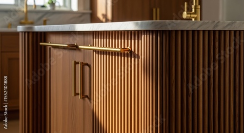 Hamptons modern kitchen island with fluted wood cabinetry and brass hardware, sophisticated coastal design for luxury home website banners and interior marketing headers