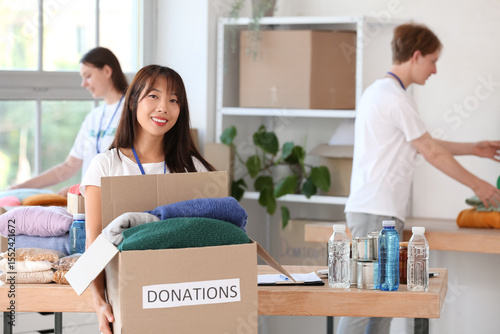 Young female volunteer with...