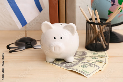 Piggy bank with money on wo...