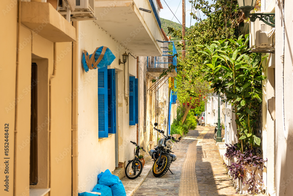 custom made wallpaper toronto digitalAgios Kirykos, Greece Greek island Ikaria empty street colorful yellow and blue building on sunny day with green plants garden and bikes