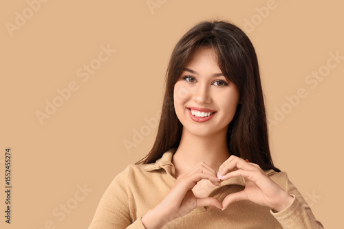 Smiling young woman making ...