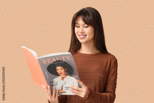 Smiling young woman reading...