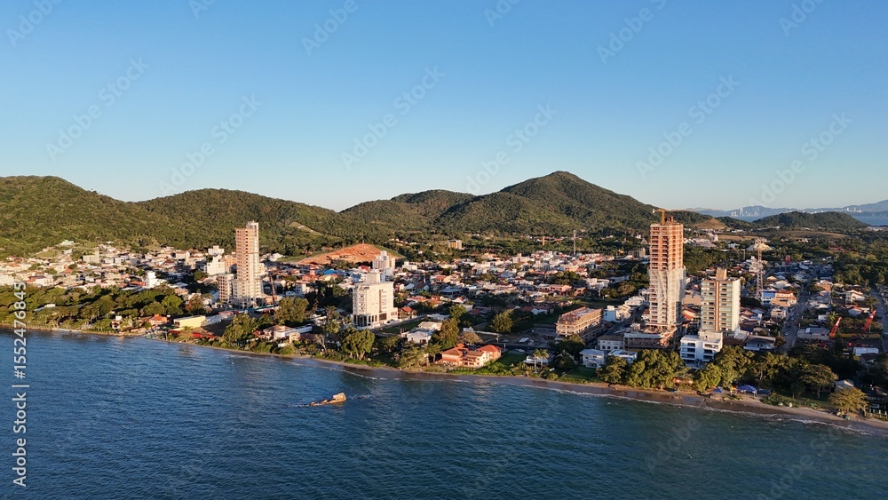 Fototapeta premium First light touches the ocean as the day begins — golden skies, calm seas, and nature in perfect balance along the Brazilian coast.