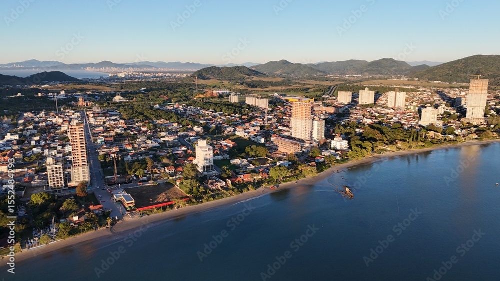 Fototapeta premium Sunrise and Sunset by the Sea – Calm Waters and Coastal Light in Brazi